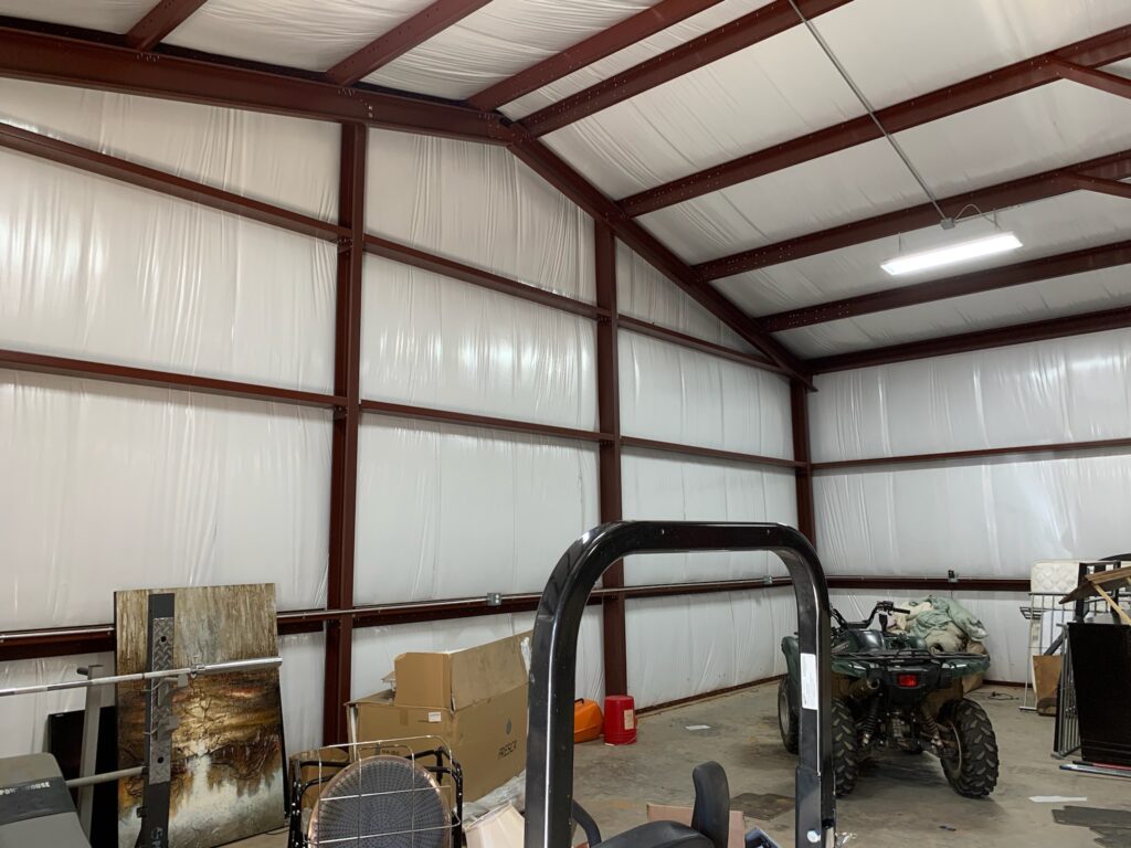 A 40x60x14 automotive service shop building stands complete with a durable steel truss frame.