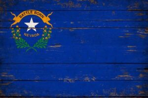 The Nevada state flag on a wooden background.