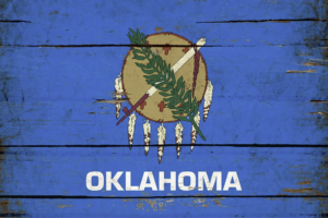 Oklahoma state flag with rustic wooden background