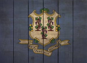 Connecticut state flag on rustic blue wooden background